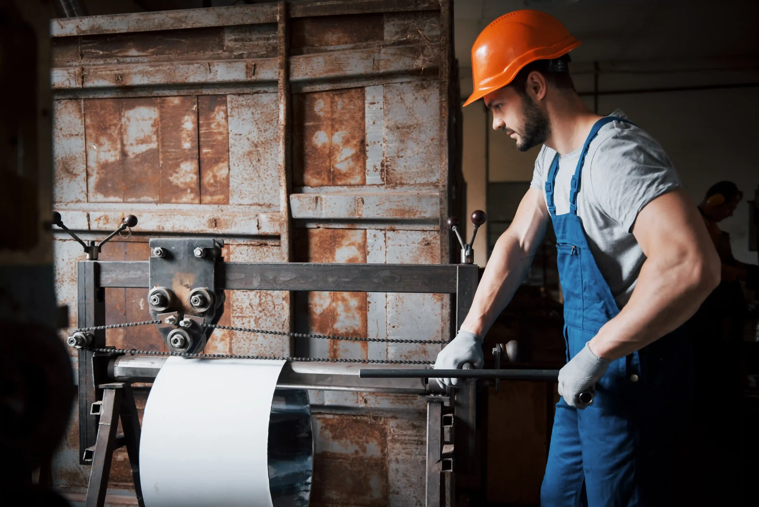 worker in hard hat at a large metalworking plant for paper and process manufacturing